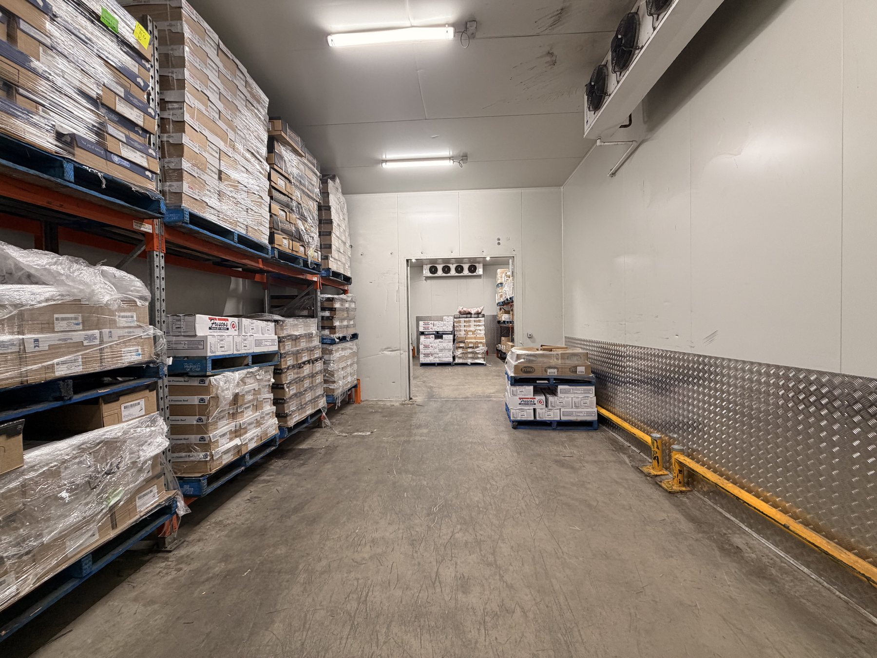 Interior of a commercial coldroom with pallet racking and evaporator equipment